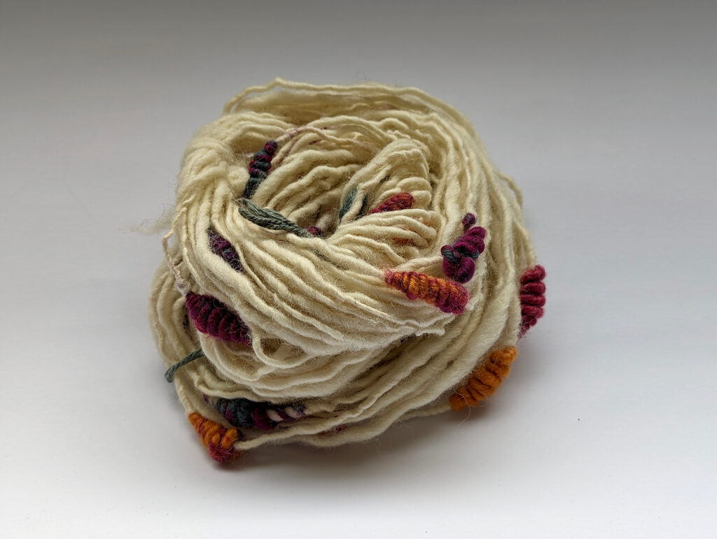 White yarn with colorful beehives